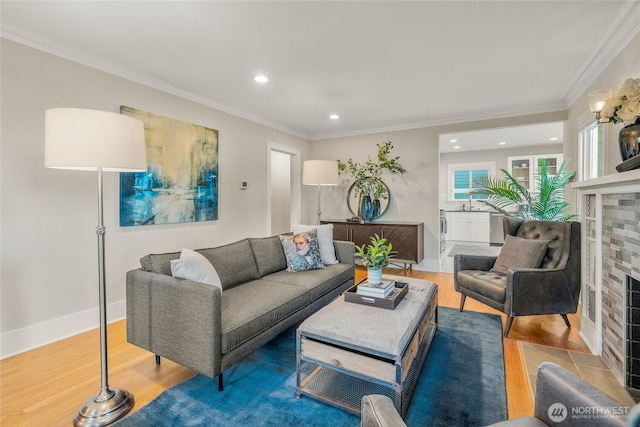 3202 NW 70th St, Seattle, WA 98117 - living area with a fireplace with flush hearth, wood finished floors, ornamental molding, recessed lighting, and baseboards