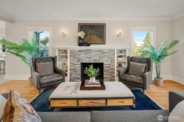 3202 NW 70th St, Seattle, WA 98117 - living room featuring ornamental molding, wood finished floors, baseboards, and a fireplace