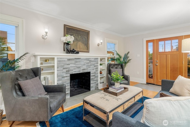 3202 NW 70th St, Seattle, WA 98117 - living area with ornamental molding, healthy amount of natural light, a tiled fireplace, and light wood-style floors