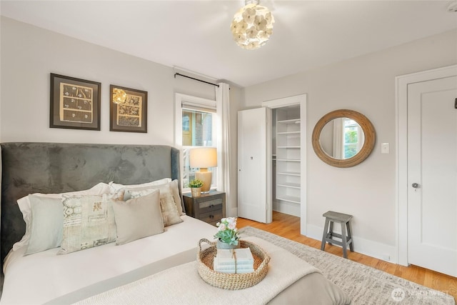 3202 NW 70th St, Seattle, WA 98117 - bedroom featuring wood finished floors, a walk in closet, and baseboards