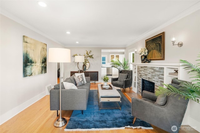 3202 NW 70th St, Seattle, WA 98117 - living room with wood finished floors, recessed lighting, crown molding, baseboards, and a stone fireplace