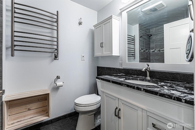 bathroom featuring radiator, toilet, tile patterned flooring, vanity, and tiled shower