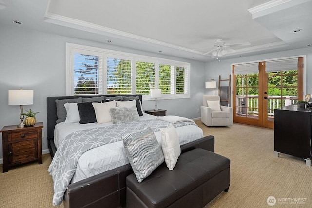 bedroom featuring a raised ceiling, access to outside, light colored carpet, ornamental molding, and french doors