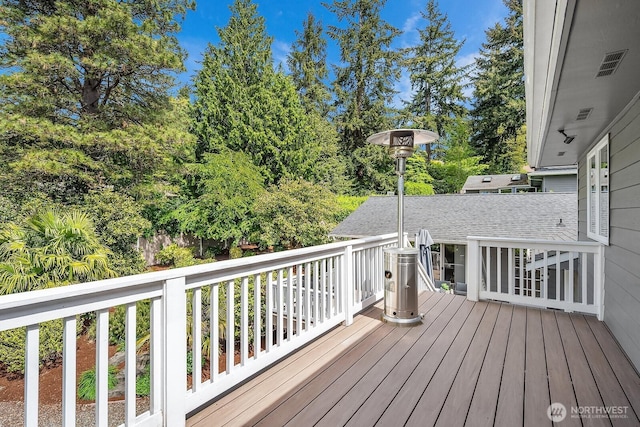 wooden terrace with view of scattered trees