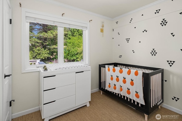 bedroom featuring ornamental molding, baseboards, light colored carpet, and a crib