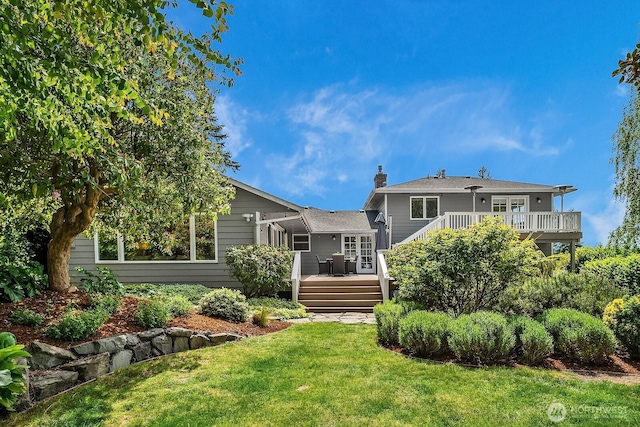 back of house with a deck, a chimney, a lawn, and french doors