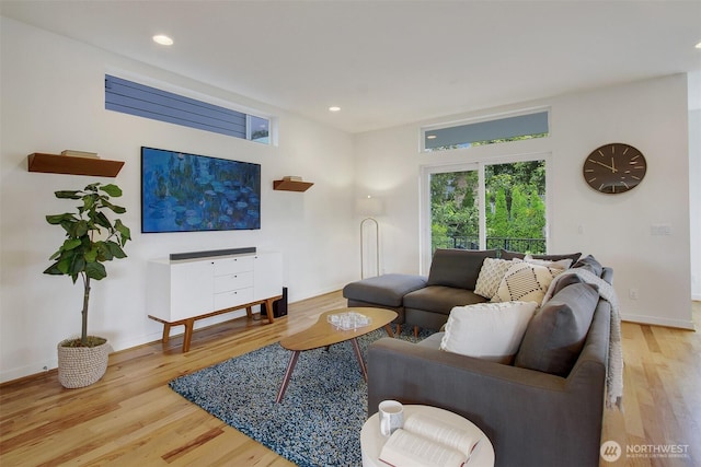 living room featuring wood finished floors, baseboards, and recessed lighting
