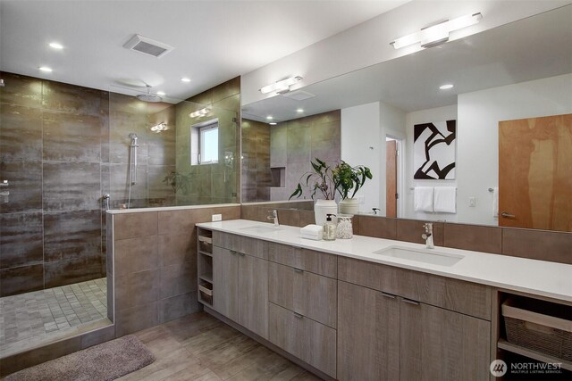 full bathroom with walk in shower, double vanity, wood finished floors, and recessed lighting
