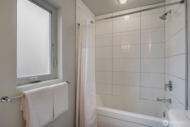 bathroom featuring healthy amount of natural light and shower / bath combo