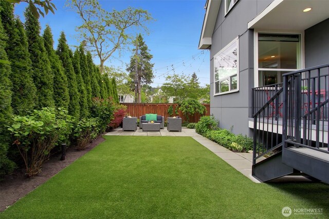 view of yard with outdoor lounge area, a patio area, and stairway