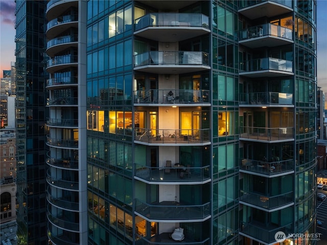 property at dusk featuring a city view and a view of apartment building / complex