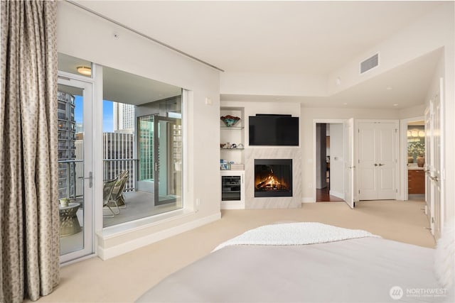 carpeted bedroom with access to exterior, a fireplace, and baseboards