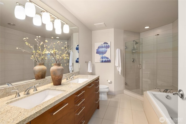 bathroom with tile patterned floors, toilet, a stall shower, double vanity, and a bath