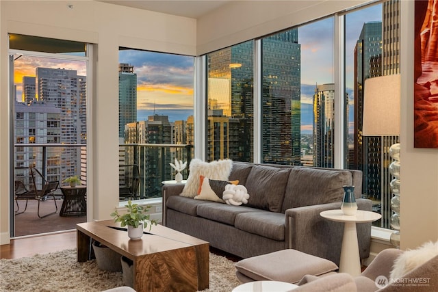 living area with a view of city and wood finished floors