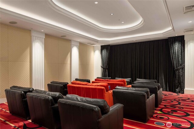 carpeted home theater featuring a tray ceiling