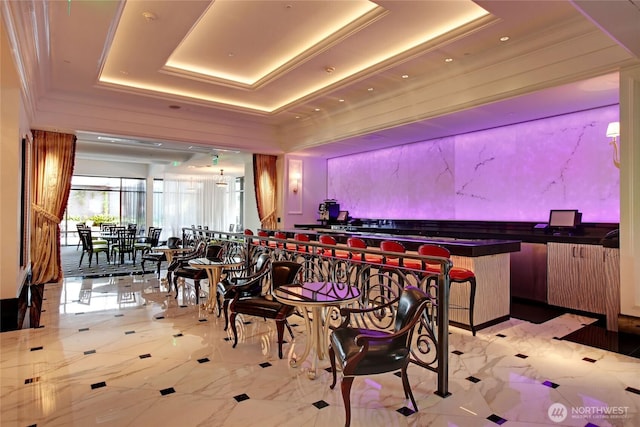 dining space featuring a raised ceiling