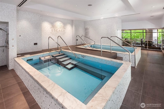 indoor pool featuring a hot tub
