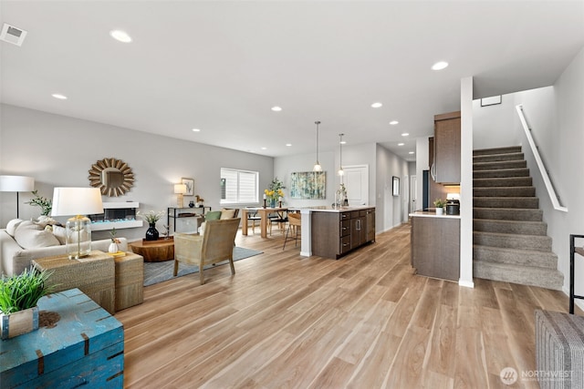 81 E Compass Ln, Allyn, WA 98524 - living room featuring light wood-style floors, stairs, and recessed lighting