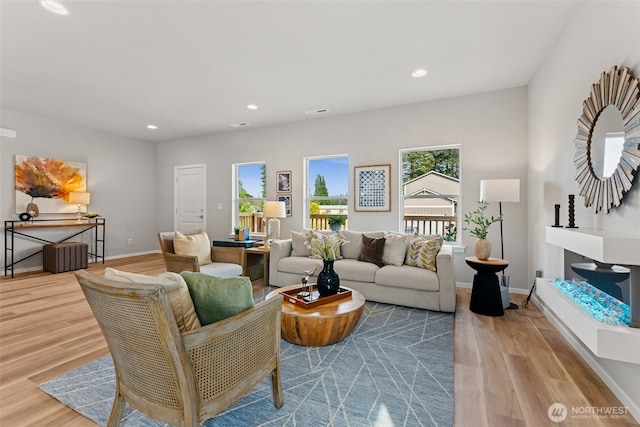 81 E Compass Ln, Allyn, WA 98524 - living area with plenty of natural light, wood finished floors, recessed lighting, and baseboards