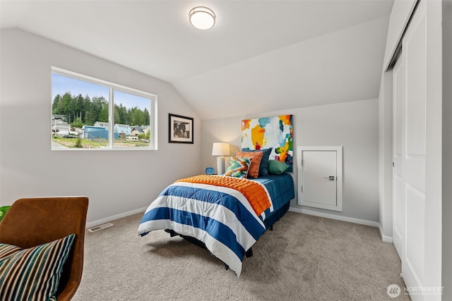 81 E Compass Ln, Allyn, WA 98524 - carpeted bedroom with lofted ceiling, baseboards, and a closet