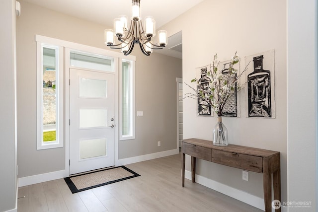 1196 8th Ave NE, Ephrata, WA 98823 - entrance foyer featuring a chandelier, light wood finished floors, and baseboards