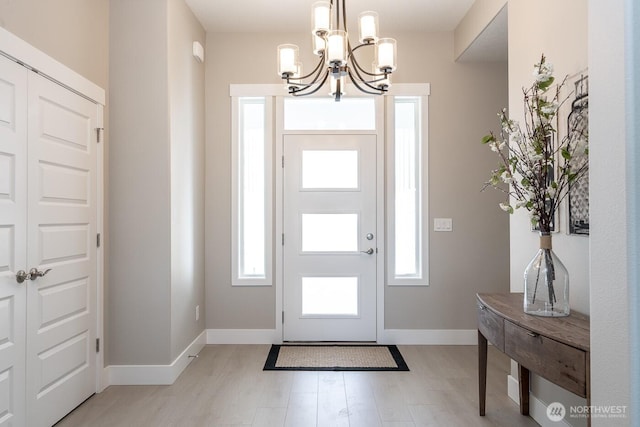 1196 8th Ave NE, Ephrata, WA 98823 - entrance foyer with a chandelier, baseboards, and light wood finished floors