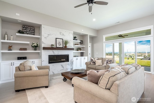 1196 8th Ave NE, Ephrata, WA 98823 - living room with a ceiling fan, built in shelves, a fireplace, light wood-style floors, and recessed lighting