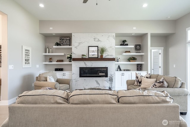 1196 8th Ave NE, Ephrata, WA 98823 - living area featuring a high end fireplace, recessed lighting, a ceiling fan, wood finished floors, and built in features