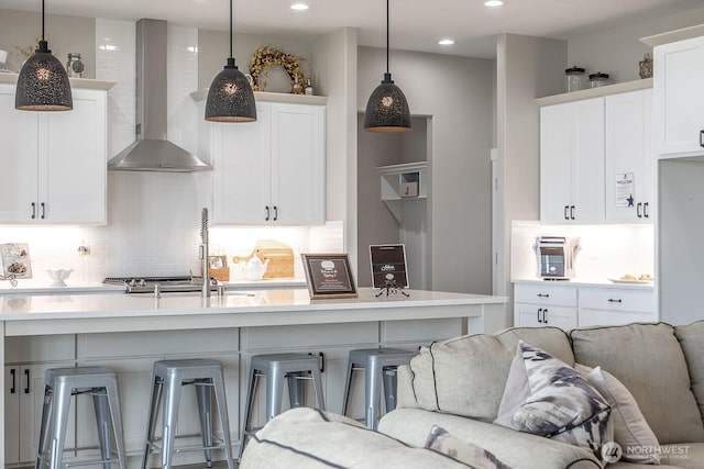 1196 8th Ave NE, Ephrata, WA 98823 - kitchen featuring wall chimney exhaust hood, decorative backsplash, light countertops, white cabinets, and recessed lighting