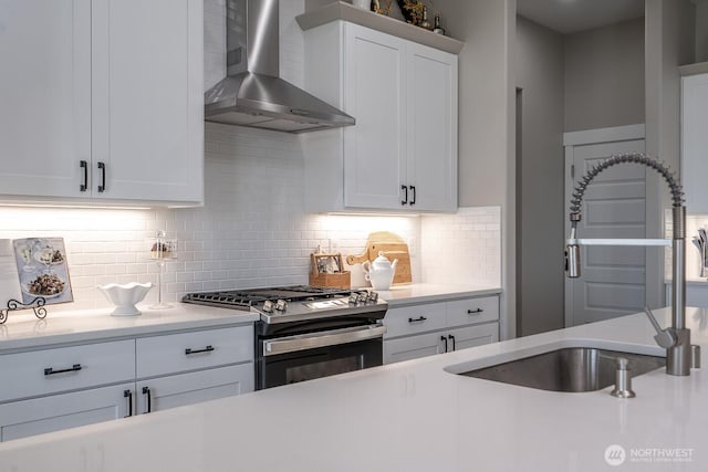 1196 8th Ave NE, Ephrata, WA 98823 - kitchen with stainless steel range with gas stovetop, wall chimney exhaust hood, a sink, and light countertops