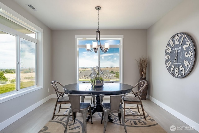 1196 8th Ave NE, Ephrata, WA 98823 - dining room featuring a chandelier, baseboards, and light wood finished floors