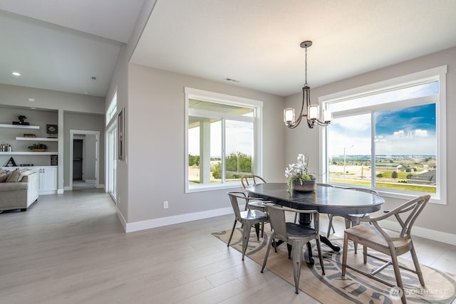 1196 8th Ave NE, Ephrata, WA 98823 - dining space featuring baseboards, light wood-style flooring, a chandelier, built in features, and recessed lighting
