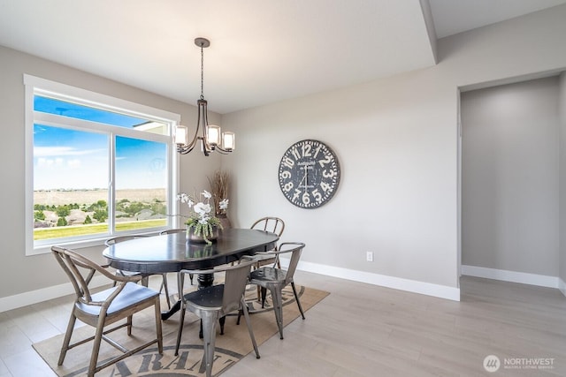 1196 8th Ave NE, Ephrata, WA 98823 - dining space featuring a chandelier, baseboards, and light wood-style floors
