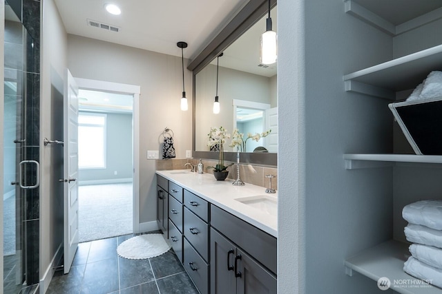 1196 8th Ave NE, Ephrata, WA 98823 - bathroom featuring double vanity, tile patterned floors, tiled shower, baseboards, and recessed lighting