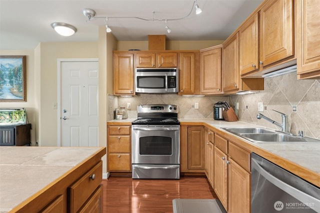 13405 97th Ave E Unit 107, Puyallup, WA 98373 - kitchen featuring stainless steel appliances, a sink, tile countertops, dark wood-style floors, and tasteful backsplash
