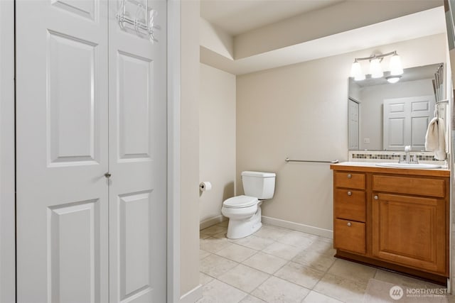 13405 97th Ave E Unit 107, Puyallup, WA 98373 - bathroom with toilet, tile patterned floors, vanity, baseboards, and a closet