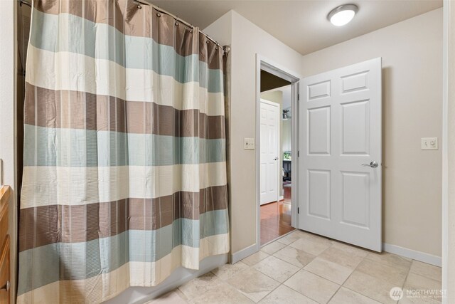 13405 97th Ave E Unit 107, Puyallup, WA 98373 - bathroom featuring baseboards, tile patterned flooring, and a shower with curtain