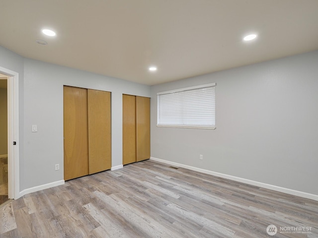 1307 SW 355th Pl, Federal Way, WA 98023 - unfurnished bedroom with multiple closets, baseboards, wood finished floors, and recessed lighting