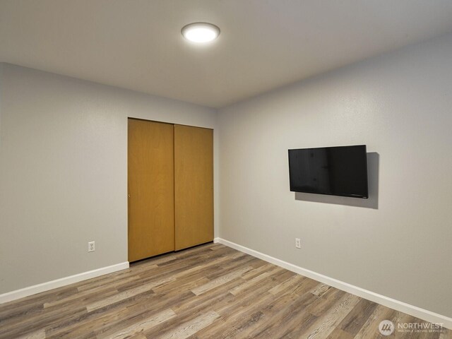 1307 SW 355th Pl, Federal Way, WA 98023 - unfurnished bedroom featuring wood finished floors, baseboards, and a closet