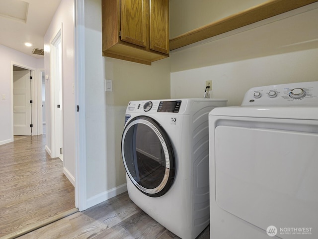 1307 SW 355th Pl, Federal Way, WA 98023 - washroom with light wood-style floors, cabinet space, washing machine and clothes dryer, baseboards, and recessed lighting