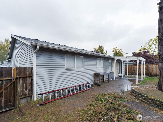 1307 SW 355th Pl, Federal Way, WA 98023 - rear view of house featuring a pergola, a fenced backyard, and a patio area