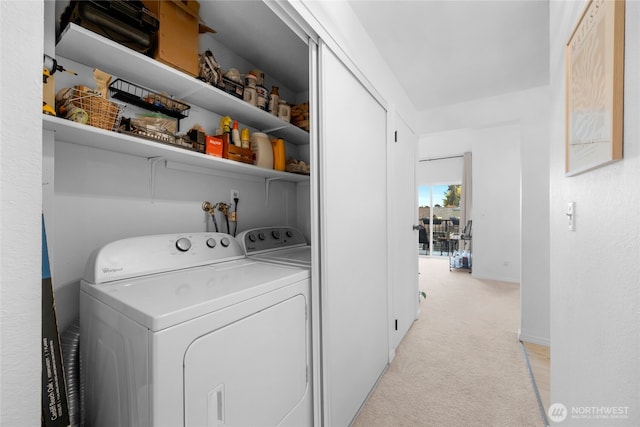 washroom featuring light carpet and washer and clothes dryer