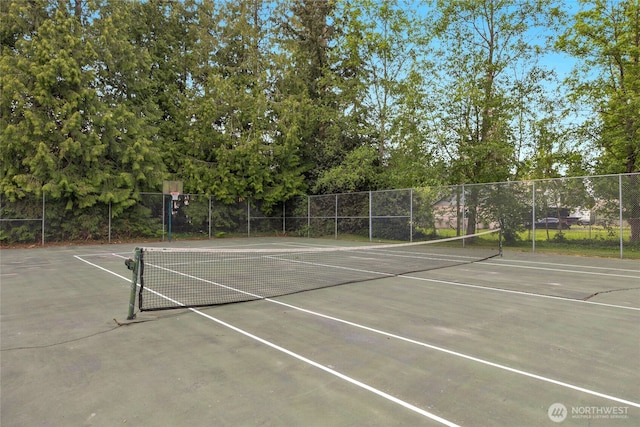 view of tennis court with fence