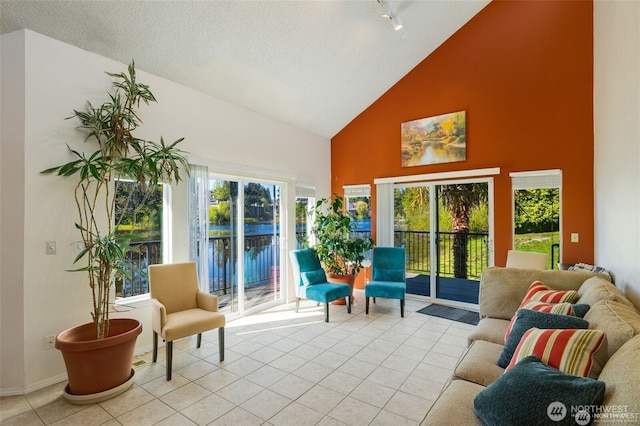 sunroom / solarium with vaulted ceiling and track lighting