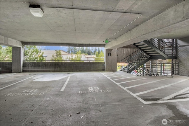 15408 Main St Unit 401, Mill Creek, WA 98012 - view of vehicle parking with fence and a parking garage