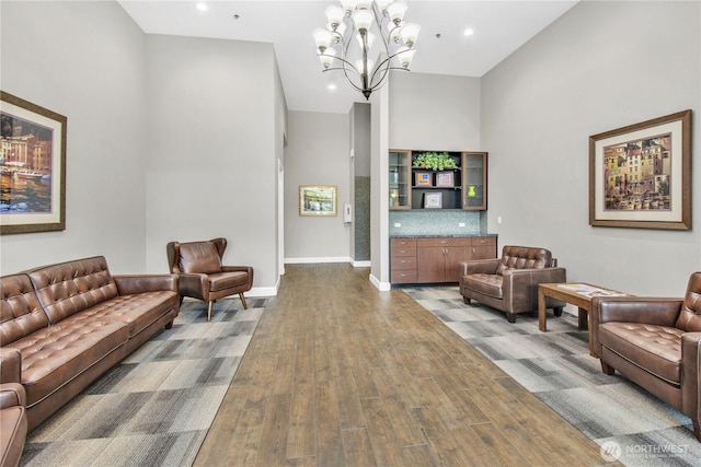 15408 Main St Unit 401, Mill Creek, WA 98012 - living room featuring a high ceiling, wood finished floors, a chandelier, recessed lighting, and baseboards