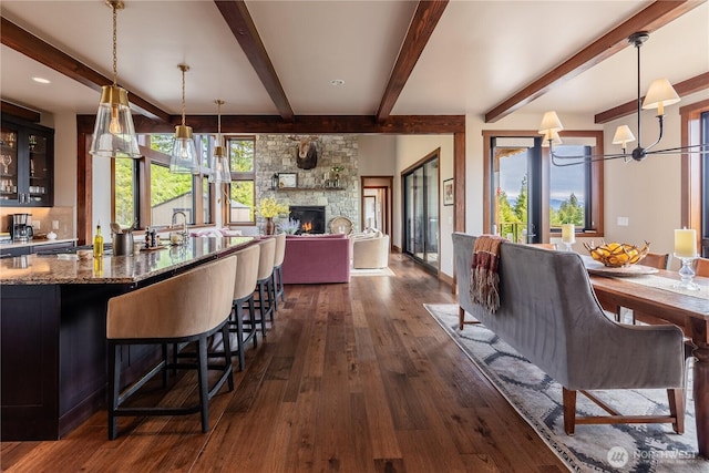 40 Eagle Ridge Dr, Cle Elum, WA 98922 - dining area with dark wood-type flooring, beam ceiling, a fireplace, and a chandelier