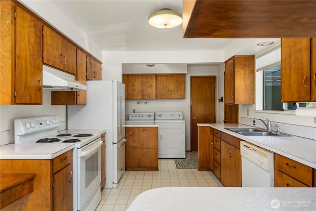 4414 Merlie Ave NE, Bremerton, WA 98310 - kitchen featuring white appliances, a sink, under cabinet range hood, separate washer and dryer, and brown cabinetry