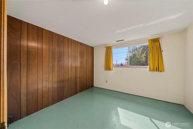 4414 Merlie Ave NE, Bremerton, WA 98310 - unfurnished room with wooden walls and finished concrete floors
