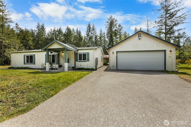 16037 Vail Loop Rd SE, Rainier, WA 98576 - ranch-style home featuring asphalt driveway, a front lawn, and an outdoor structure
